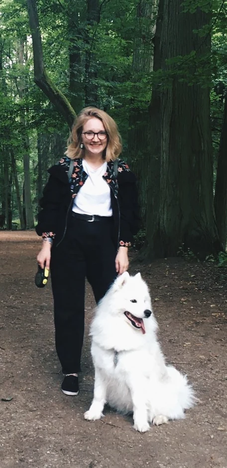 Maria walking a friend’s samoyed in a forest park